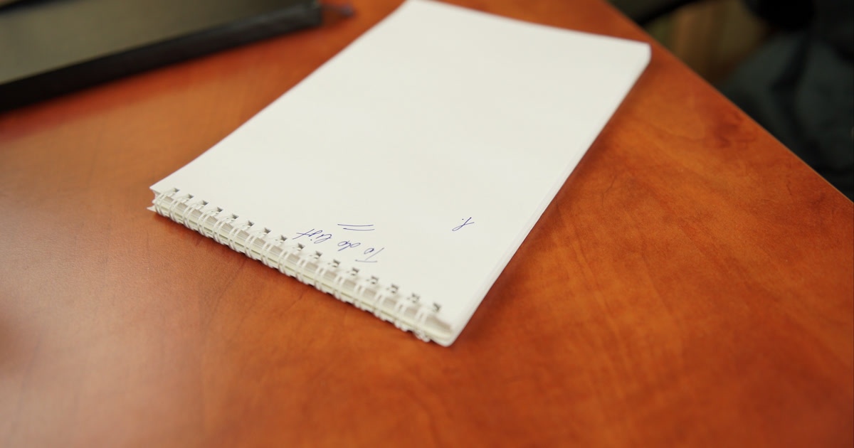 Open notebook with pen on a desk ready for writing