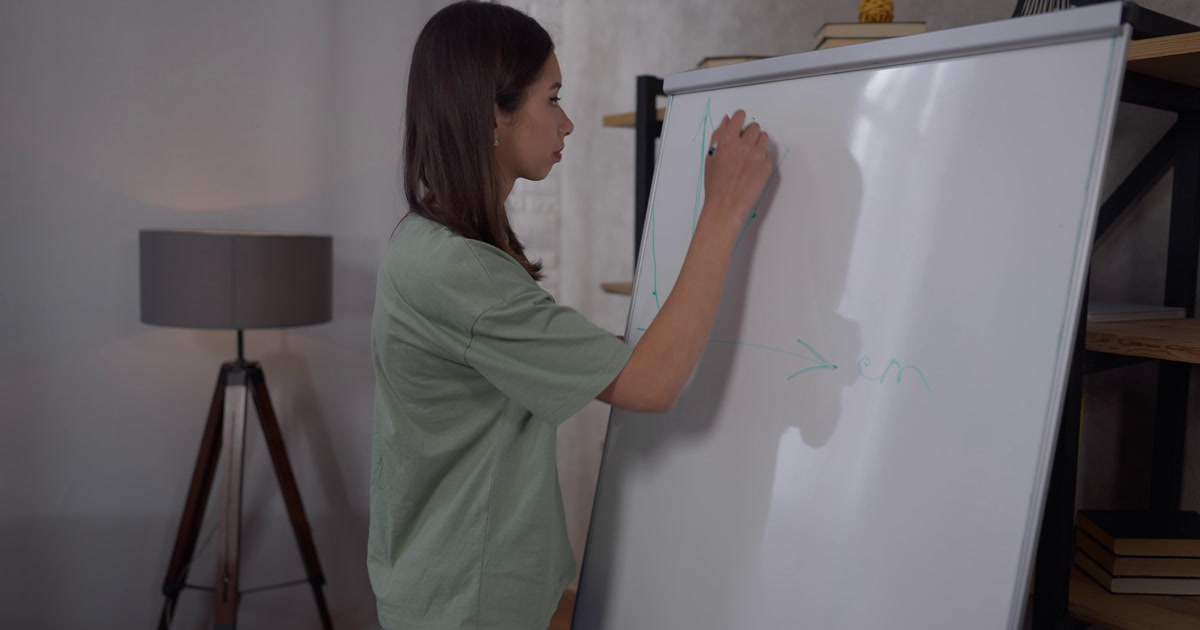 Woman drawing a planning graph on a whiteboard